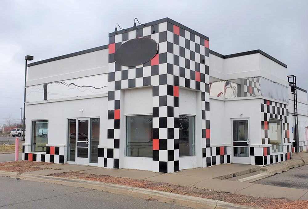 A building with a checkered pattern on the side, a Keystone Commercial Real Estate investment sale.