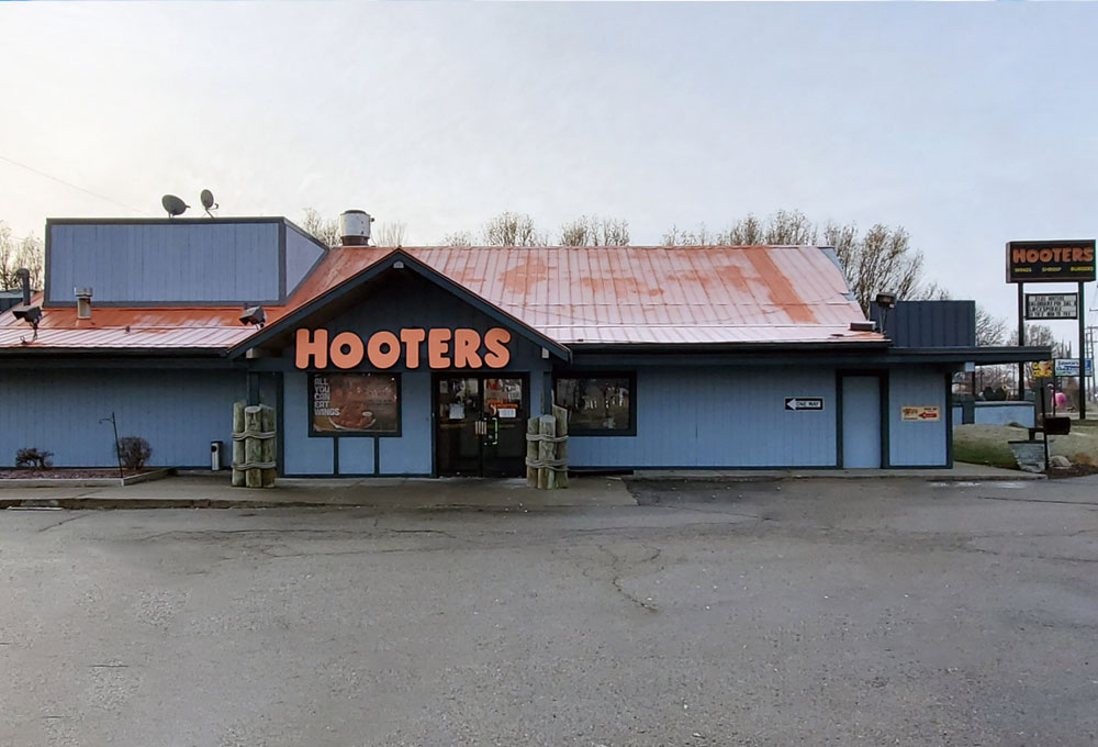 A restaurant named Hooters with a prominent sign displaying the name.