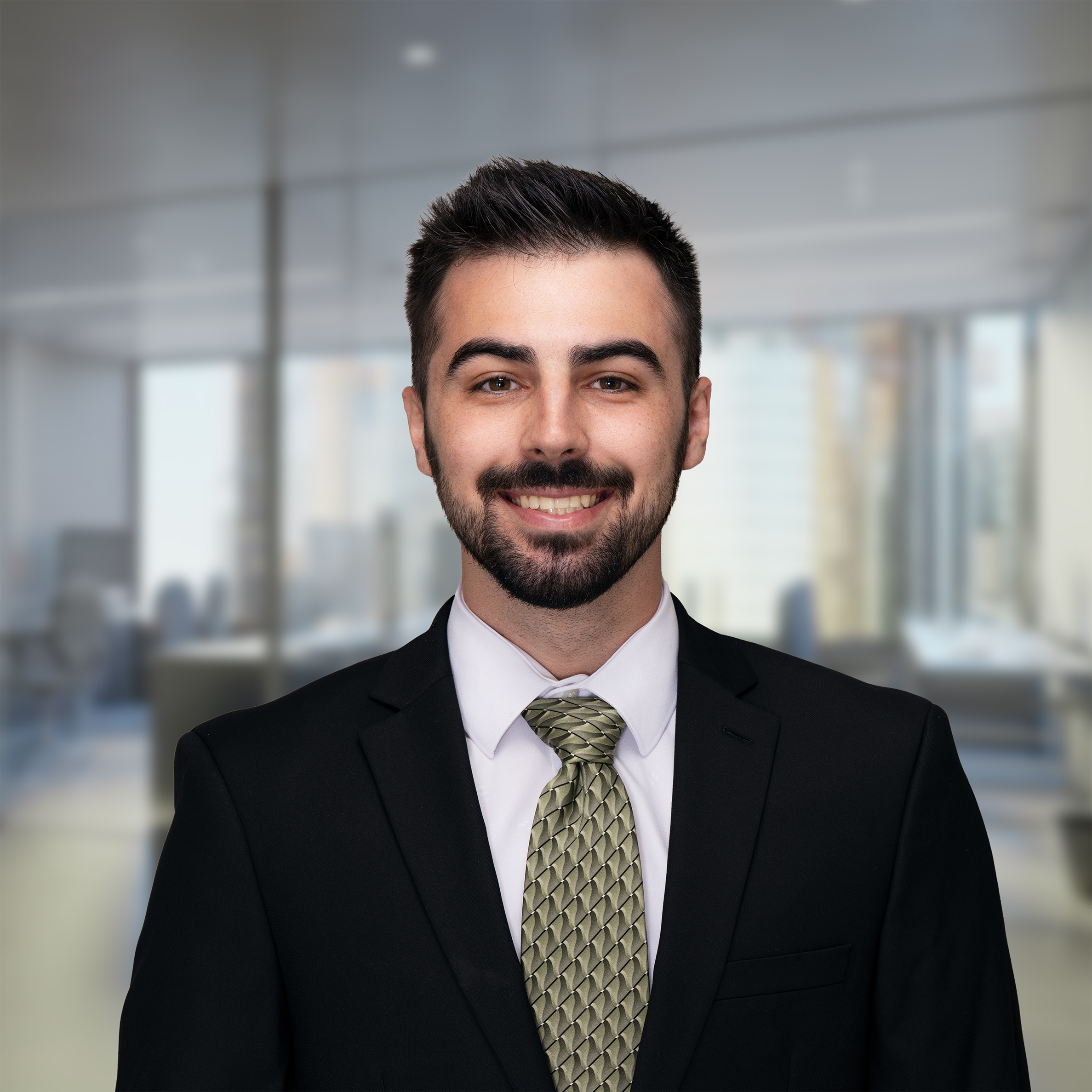 An image of Peter Abro, an advisor at Keystone Commercial Real Estate, in a black suit and blue tie.